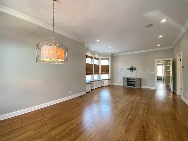 unfurnished living room featuring dark wood-type flooring, recessed lighting, baseboards, and ornamental molding