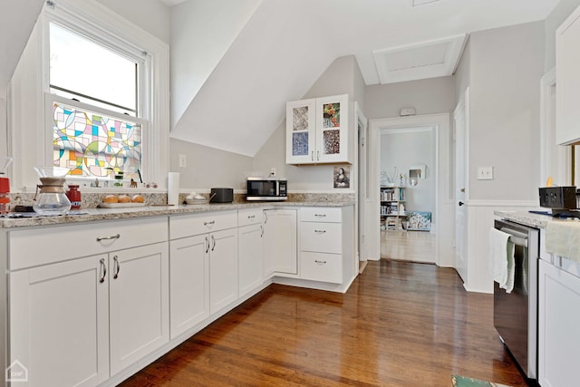 kitchen with glass insert cabinets, light stone countertops, dark wood finished floors, white cabinets, and stainless steel appliances