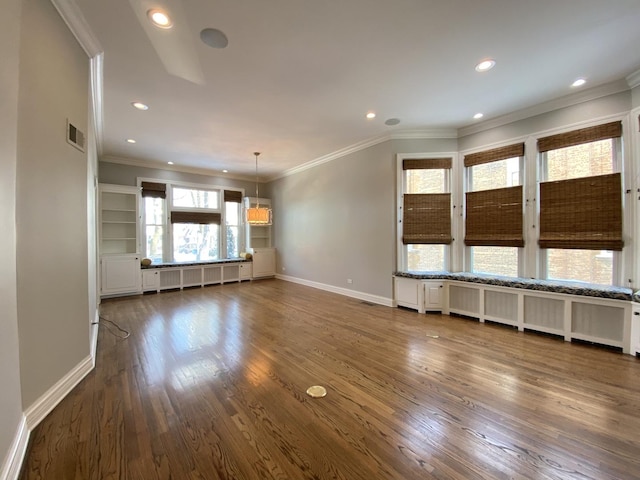 unfurnished living room featuring visible vents, wood finished floors, radiator, crown molding, and baseboards