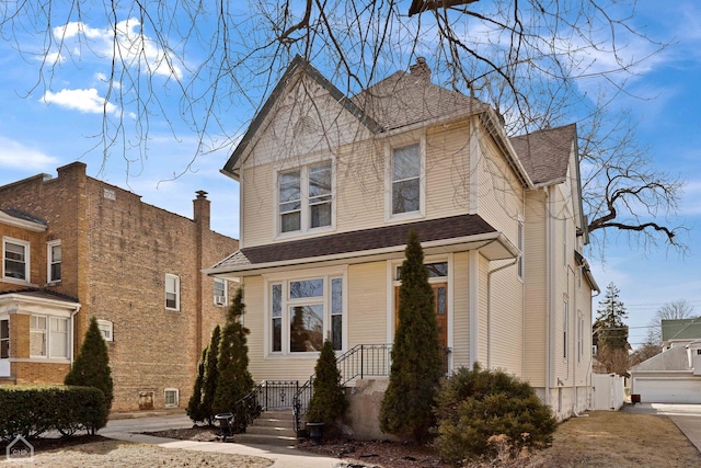 view of front facade featuring roof with shingles