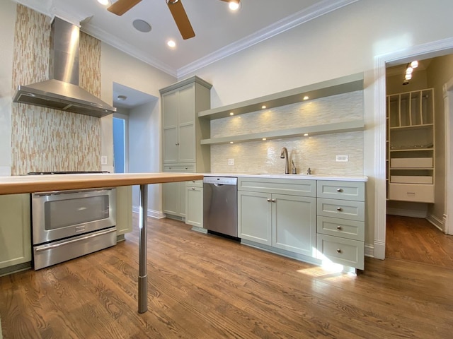 kitchen featuring open shelves, ceiling fan, wall chimney range hood, dishwasher, and a sink