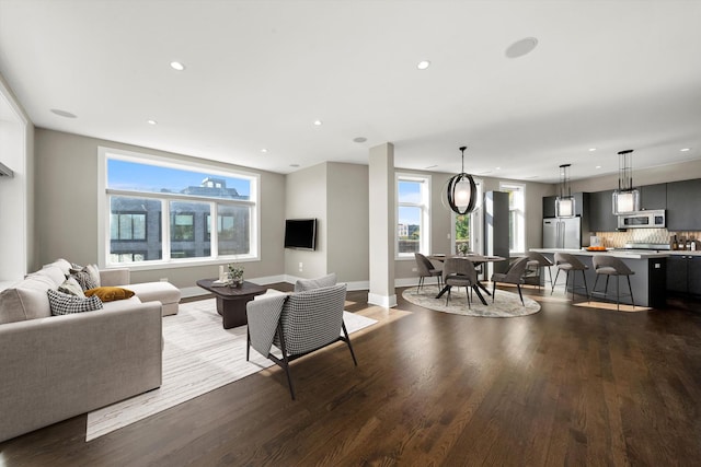 living area featuring recessed lighting, baseboards, and wood finished floors