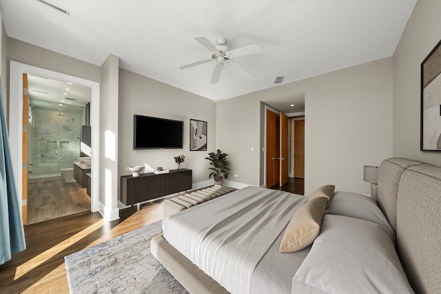 bedroom featuring ceiling fan, visible vents, baseboards, and wood finished floors