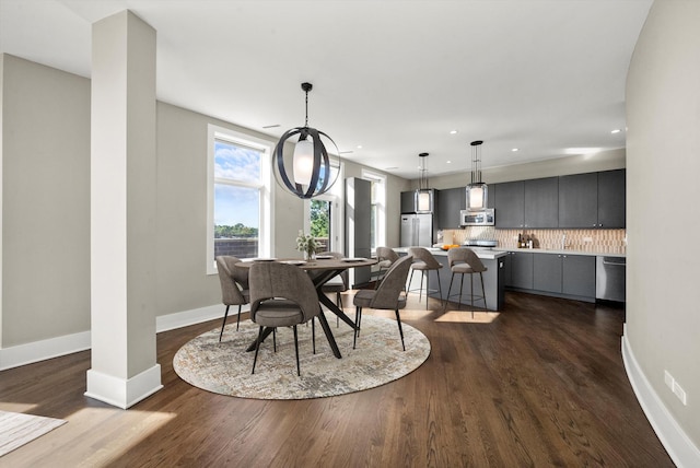 dining room with recessed lighting, baseboards, and dark wood-type flooring