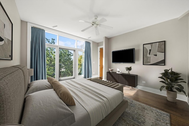 bedroom featuring floor to ceiling windows, ceiling fan, baseboards, and wood finished floors