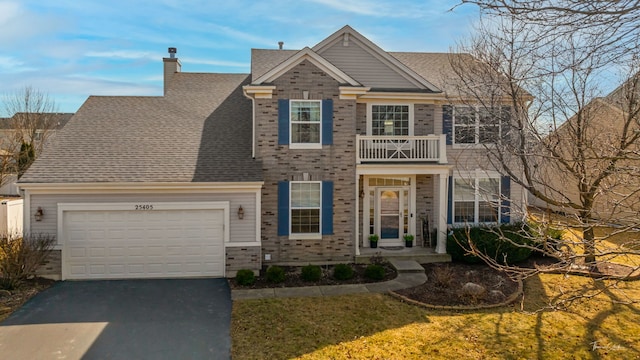 view of front of house featuring a shingled roof, a chimney, driveway, a balcony, and an attached garage