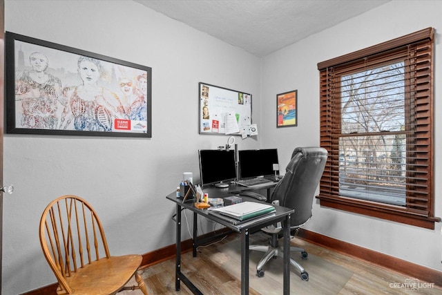 office area featuring baseboards and wood finished floors