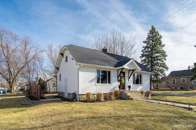 view of front facade featuring a chimney, a front lawn, and a shingled roof