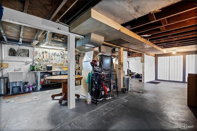 unfinished basement featuring a workshop area