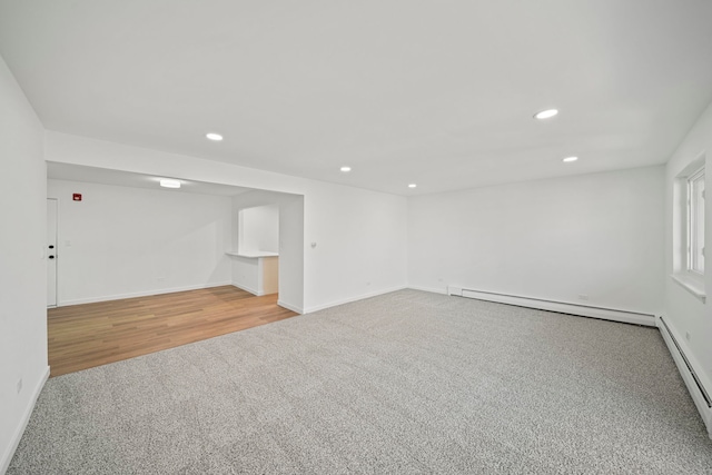 carpeted empty room with recessed lighting, baseboards, and a baseboard radiator