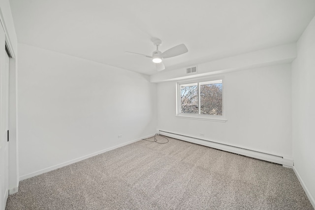 carpeted spare room featuring a baseboard heating unit, baseboards, visible vents, and ceiling fan