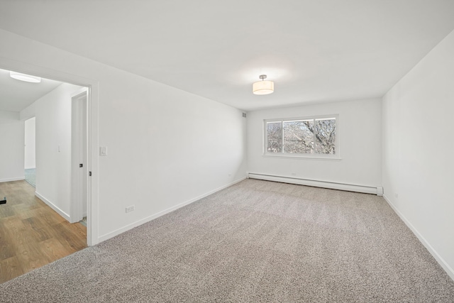 unfurnished room featuring baseboards, carpet, and a baseboard radiator