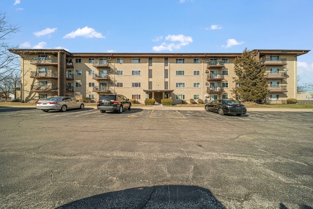 view of property featuring uncovered parking