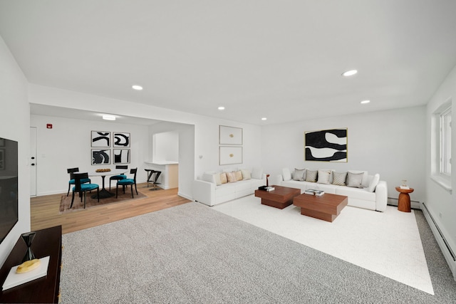 living area featuring recessed lighting, baseboards, baseboard heating, and wood finished floors