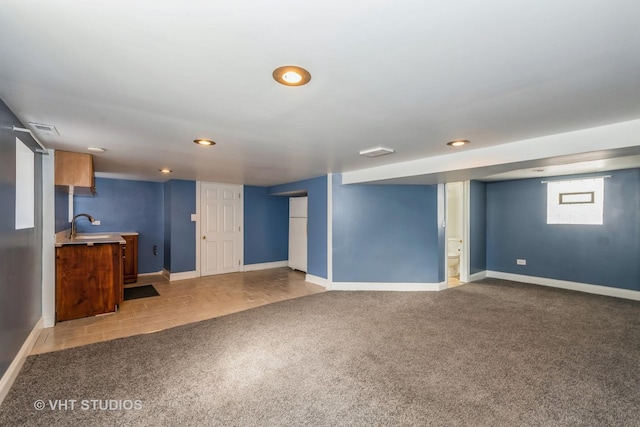 unfurnished living room with carpet flooring, recessed lighting, baseboards, and visible vents