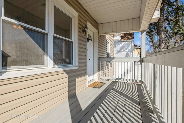 wooden terrace featuring covered porch