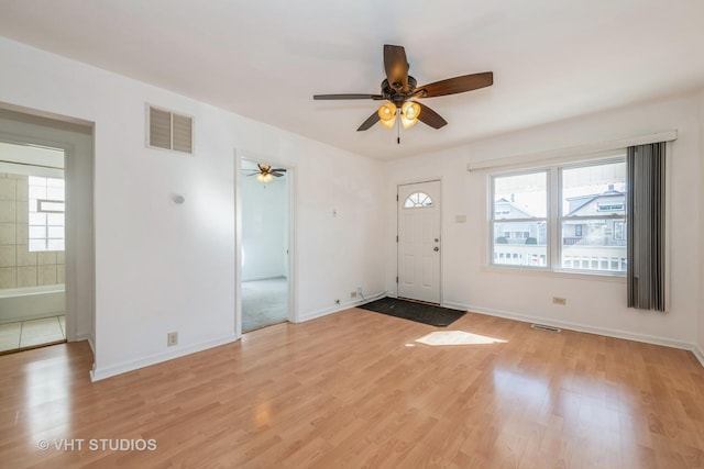 entryway with a wealth of natural light, visible vents, and light wood-style floors