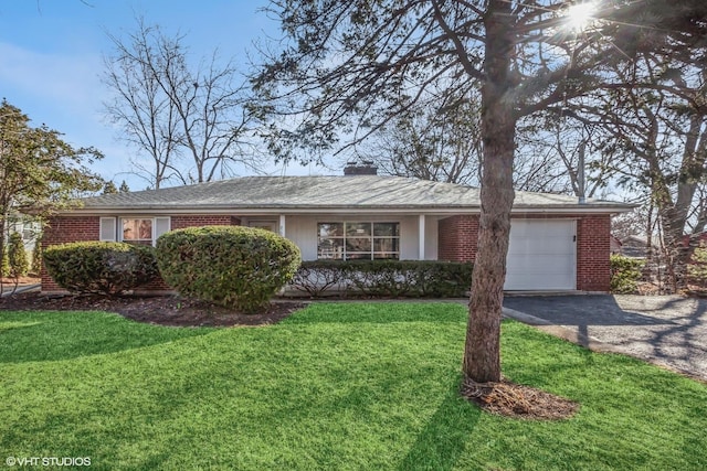 ranch-style house featuring a front yard, driveway, an attached garage, a chimney, and brick siding