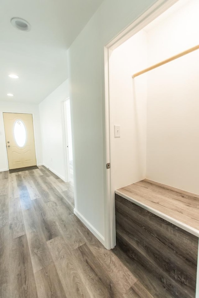 corridor with recessed lighting, baseboards, and wood finished floors