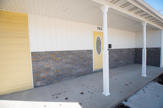 view of exterior entry featuring stone siding