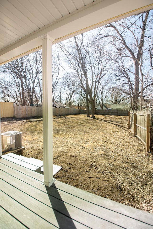 view of yard with central air condition unit and a fenced backyard