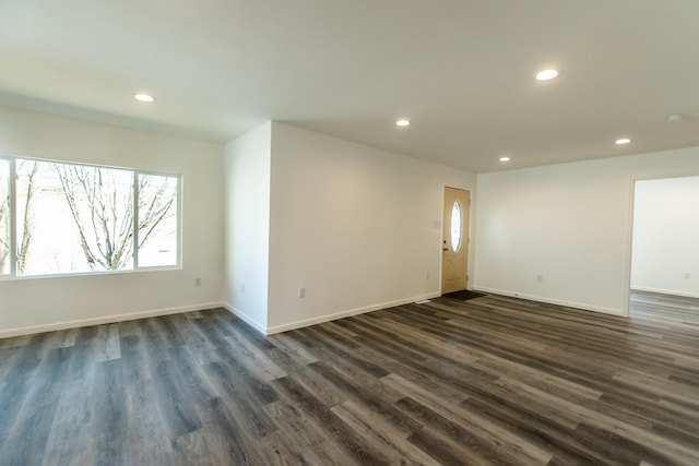 unfurnished room featuring recessed lighting, baseboards, and dark wood-style flooring