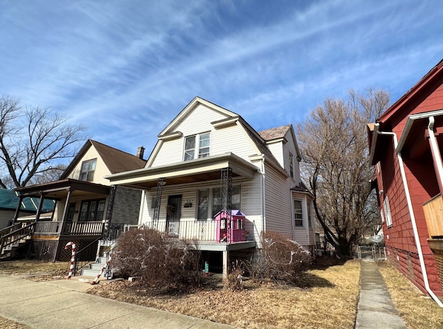 view of front of home with a gambrel roof, roof with shingles, and a porch