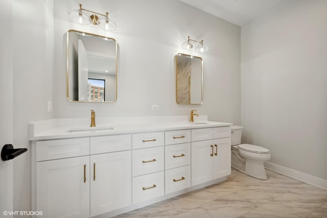 bathroom featuring double vanity, toilet, marble finish floor, and a sink