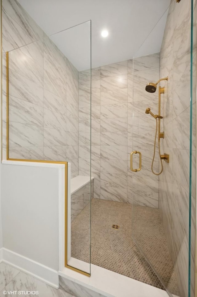 full bath featuring a marble finish shower