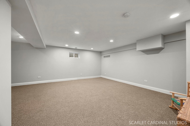 finished below grade area with baseboards, carpet, visible vents, and recessed lighting