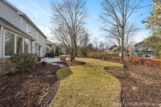 view of yard featuring a residential view, fence, and a patio