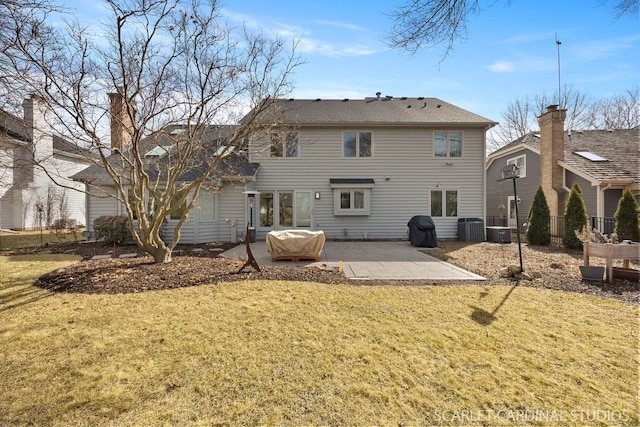 back of house with a yard, a patio, and central AC