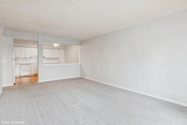 empty room with light carpet and baseboards