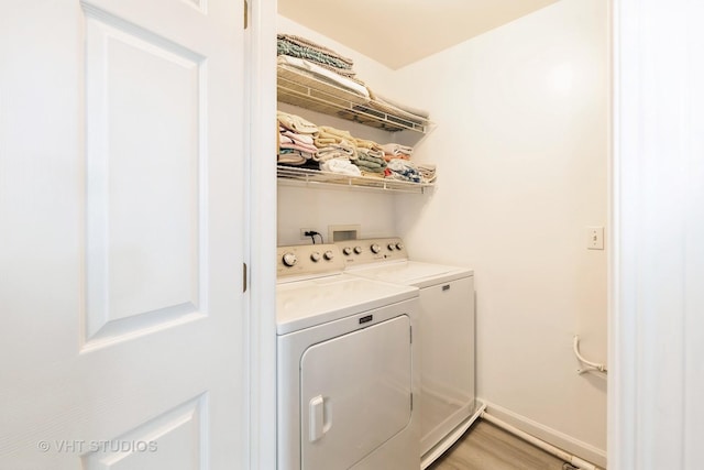 3414 Blue Ridge Dr Unit 3414, Carpentersville, IL 60110 - clothes washing area featuring separate washer and dryer, baseboards, light wood-style floors, and laundry area