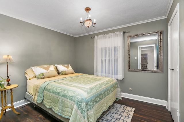 bedroom featuring ornamental molding, wood finished floors, baseboards, and a chandelier