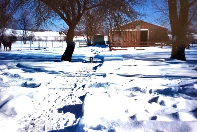 yard covered in snow featuring fence