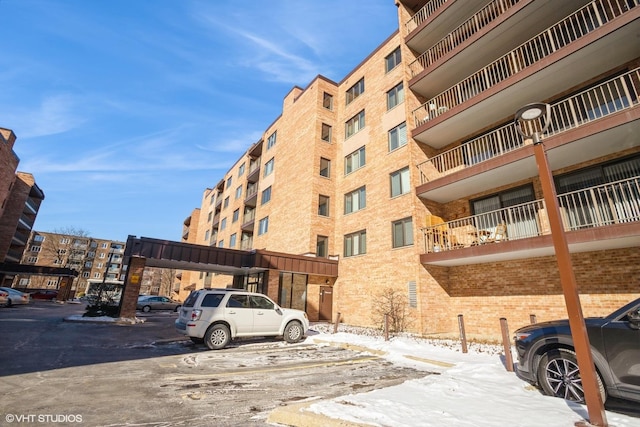 view of building exterior with uncovered parking