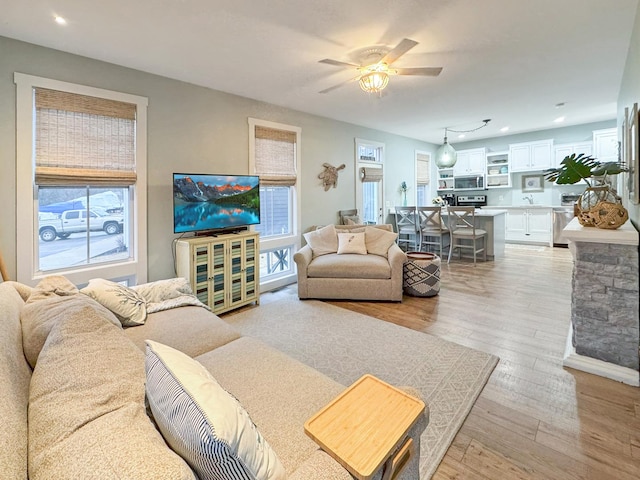 living room featuring light wood-style flooring, recessed lighting, and a ceiling fan