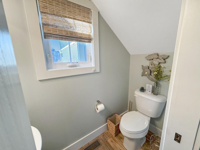 bathroom featuring visible vents, baseboards, toilet, and wood finished floors