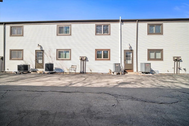 back of property featuring central AC unit