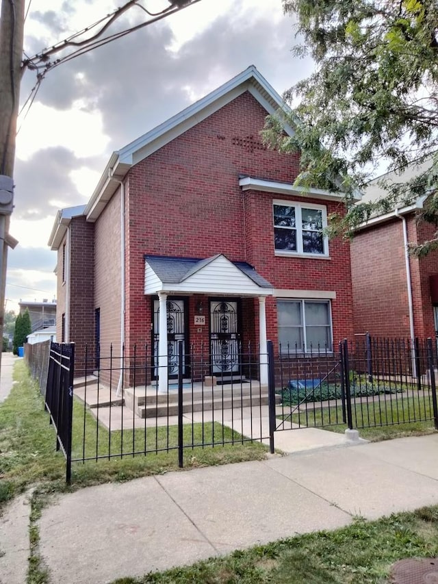 view of front of house with brick siding and a fenced front yard