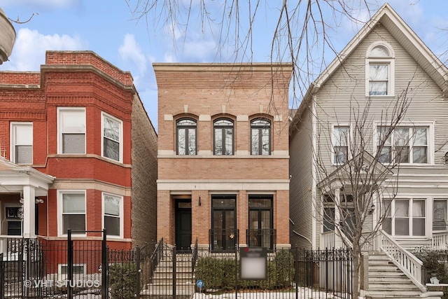 view of front of house featuring a fenced front yard and brick siding