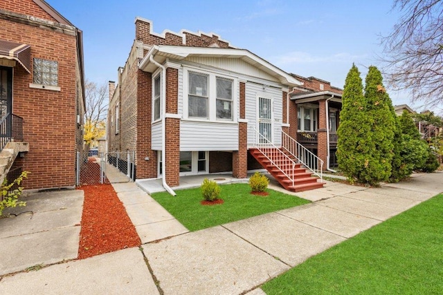 view of front of home with brick siding and a gate