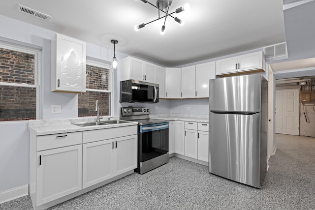 kitchen with a sink, visible vents, appliances with stainless steel finishes, and white cabinets