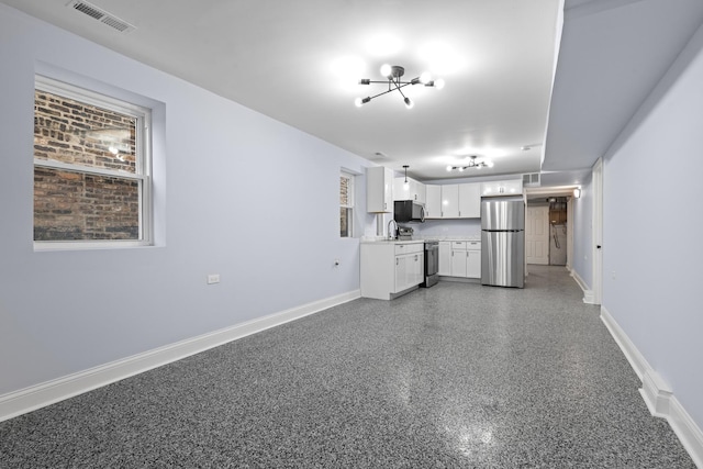 kitchen featuring visible vents, baseboards, light countertops, appliances with stainless steel finishes, and white cabinets