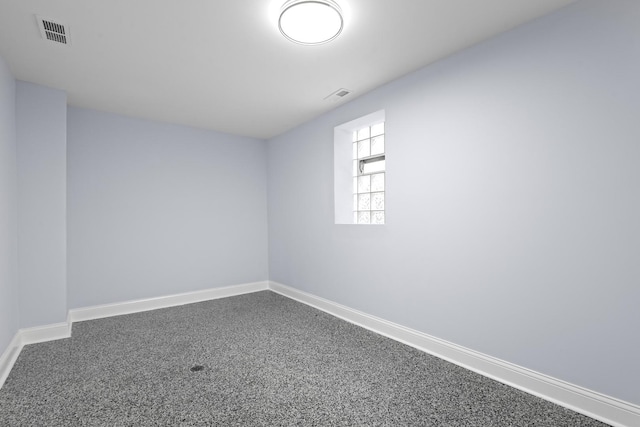 spare room with visible vents, baseboards, and carpet floors