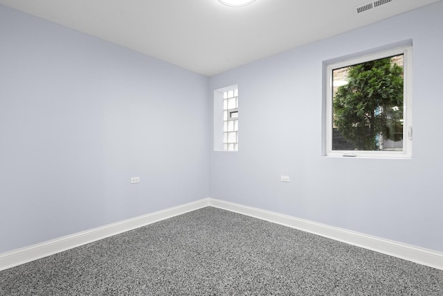 unfurnished room with visible vents and baseboards