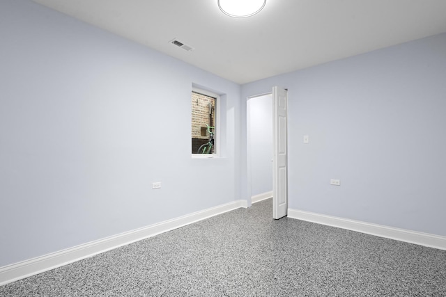 unfurnished room featuring visible vents and baseboards