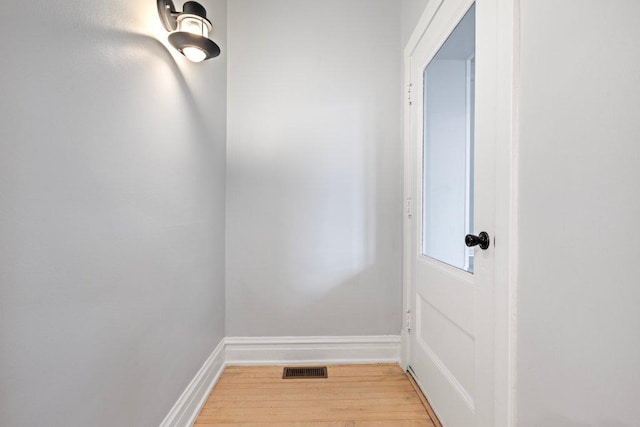 entryway featuring visible vents, light wood-type flooring, and baseboards