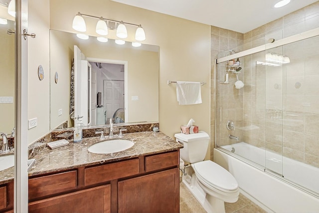 bathroom featuring vanity, tile patterned floors, toilet, and enclosed tub / shower combo